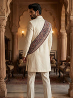 Ivory velvet achkan with hand embroidered and metal broach with stall